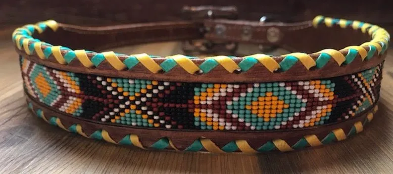 Genuine leather dog collar with teal, white, yellow and burgundy navajo beaded inlay design, a rawhide wrapped edge